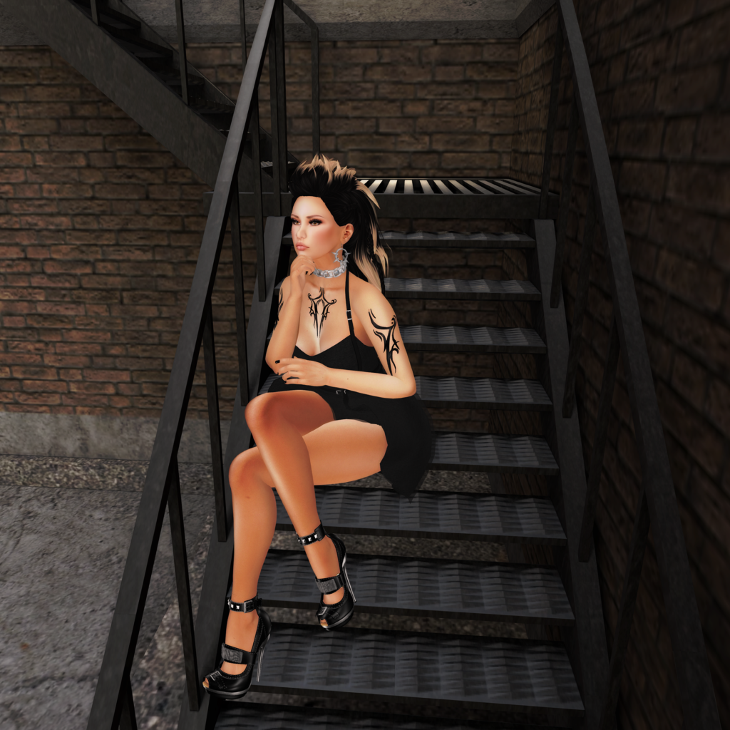 A female Second Life avatar with tattoos sits on the stairs.