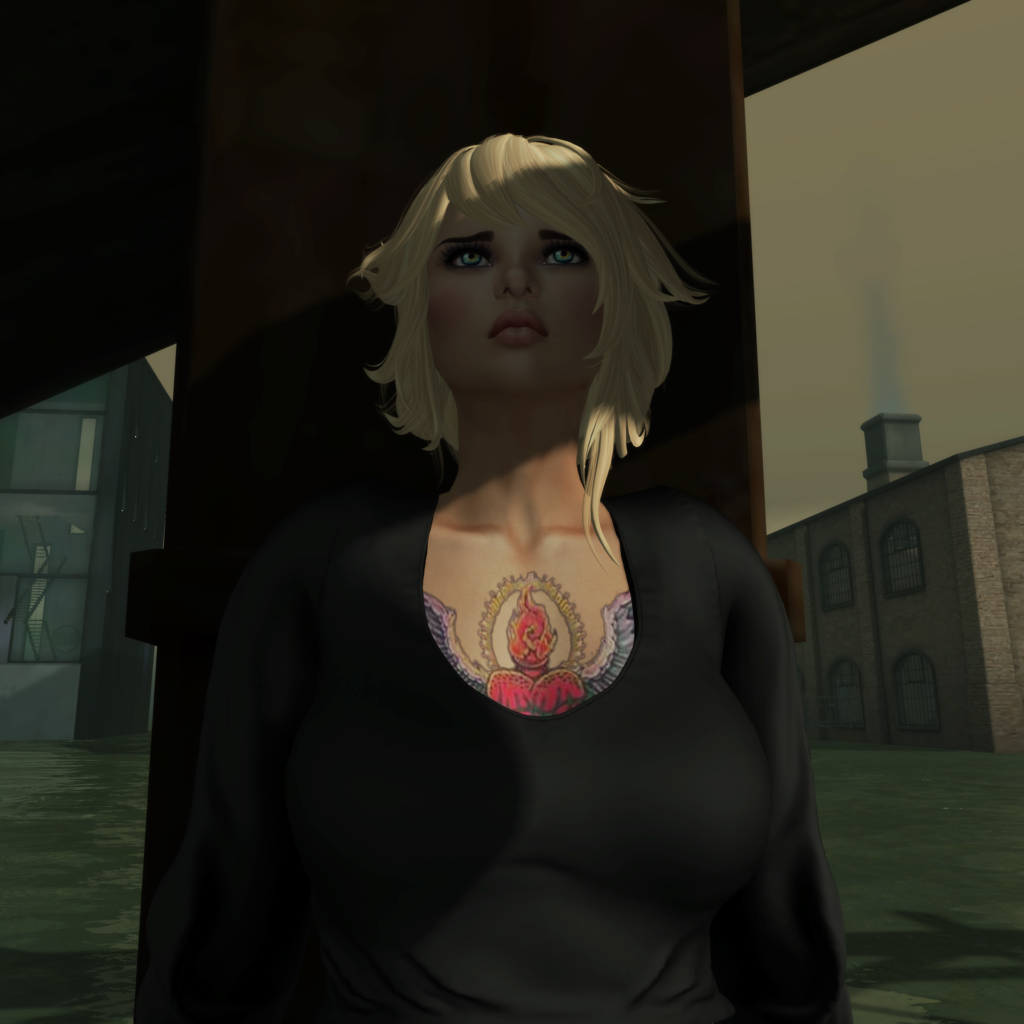 A female Second Life avatar with a black shirt and a tattoo looks up from the shadows.