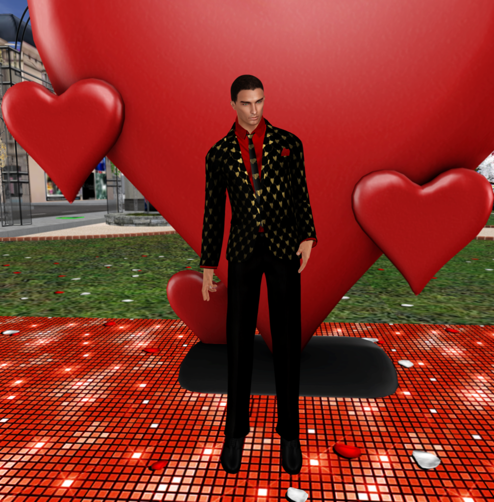 A male Second Life avatar stands in front of a heart while wearing a black and gold suit.