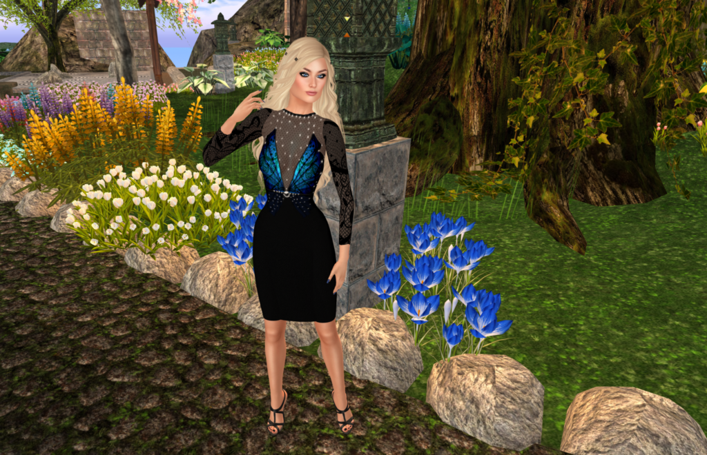 A female Second Life avatar wears a black dress with a sheer top and blue butterfly wings on the front.