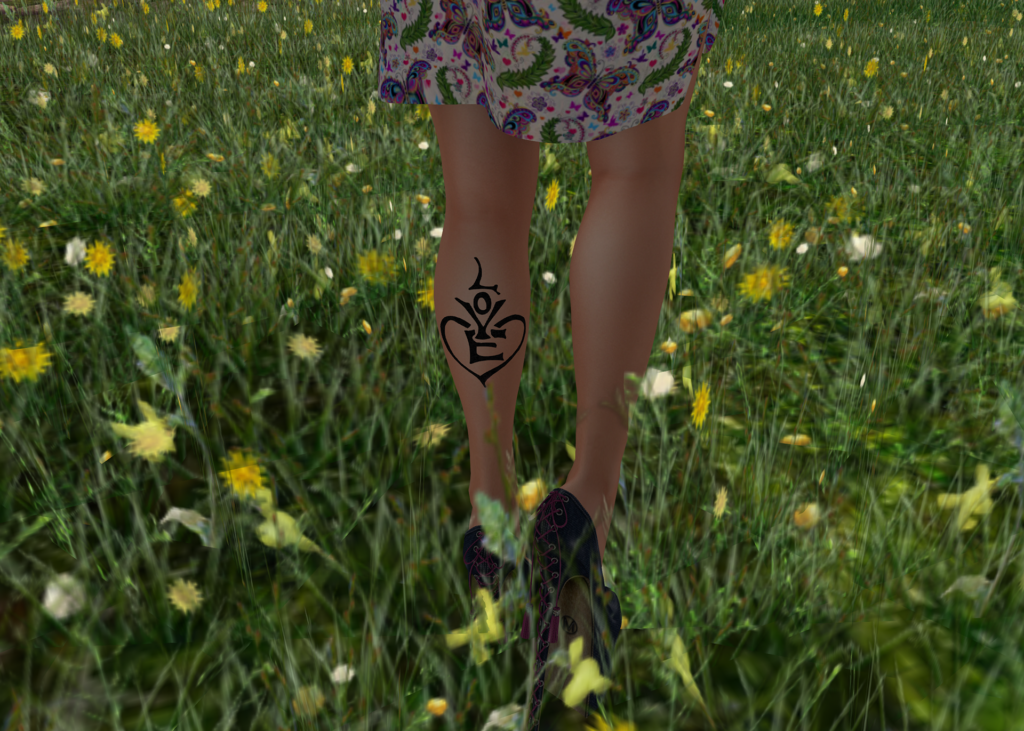A female Second Life avatar shows off a Love tattoo on the back of her calf.