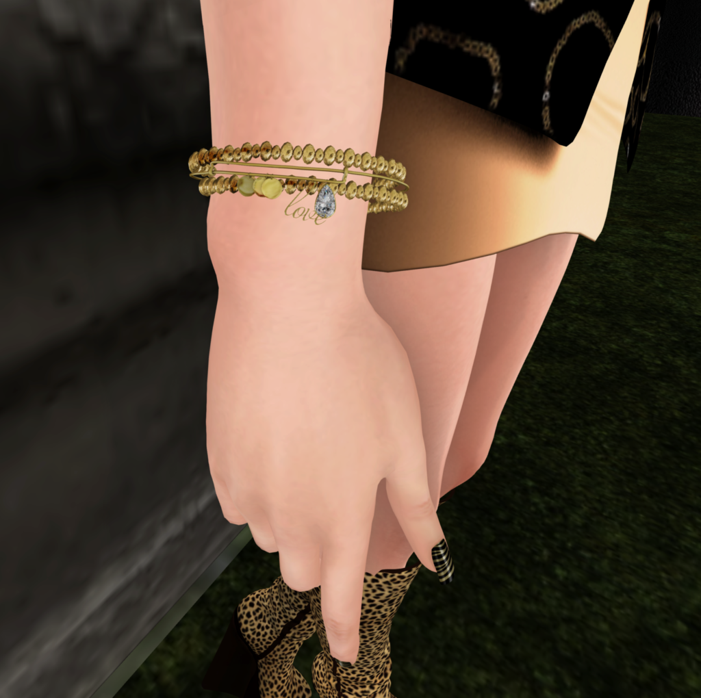A Second Life woman shows off her bracelet from The Free Dove