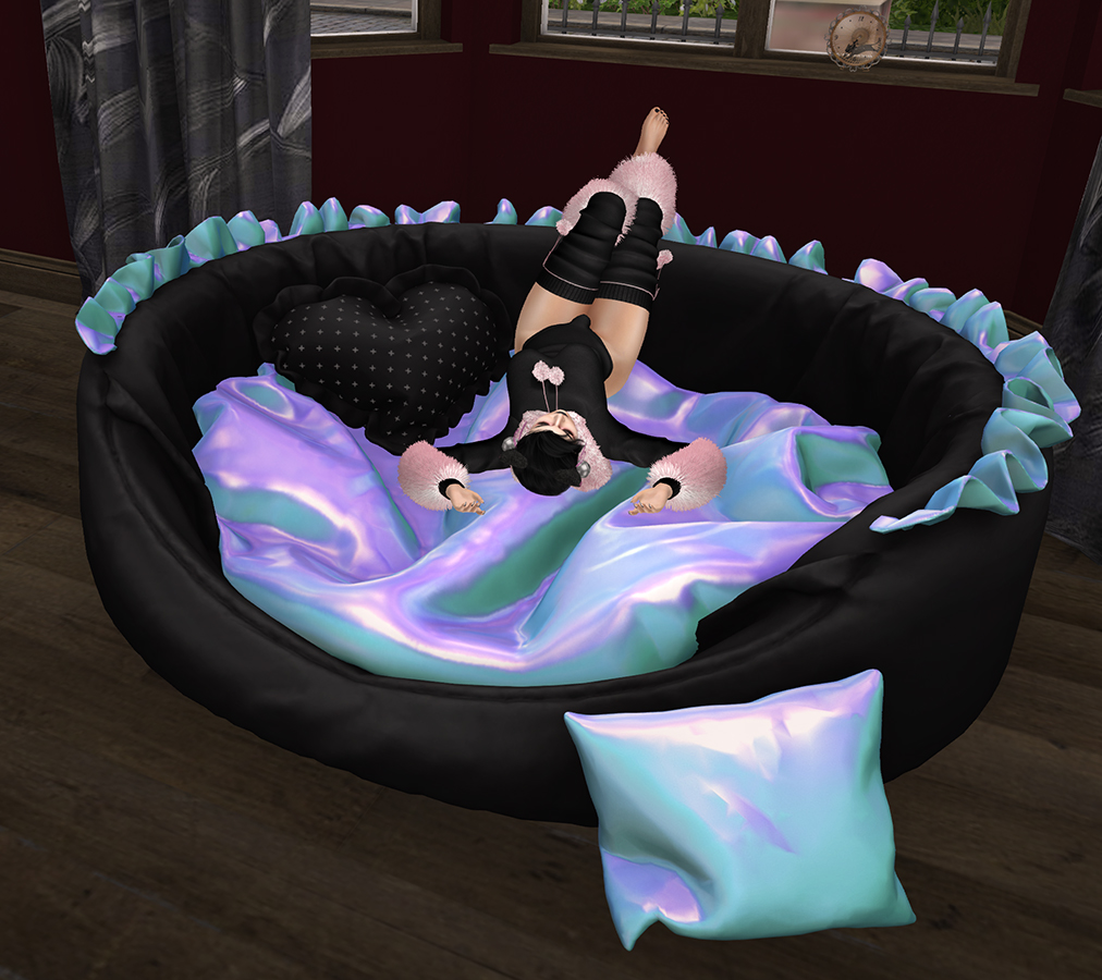 A Second Life cat girl plays in Backbone's Kitten's Comfy Nest cat bed.